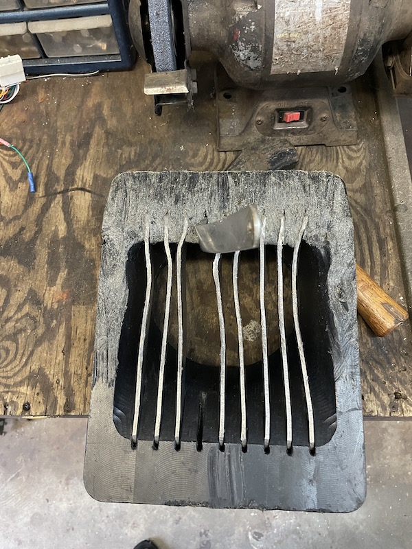 Severely bent outboard jet intake grate bar before straightening