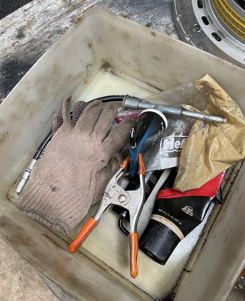 Outboard jet greasing kit with low-pressure gun, approved grease, gloves, and supplies