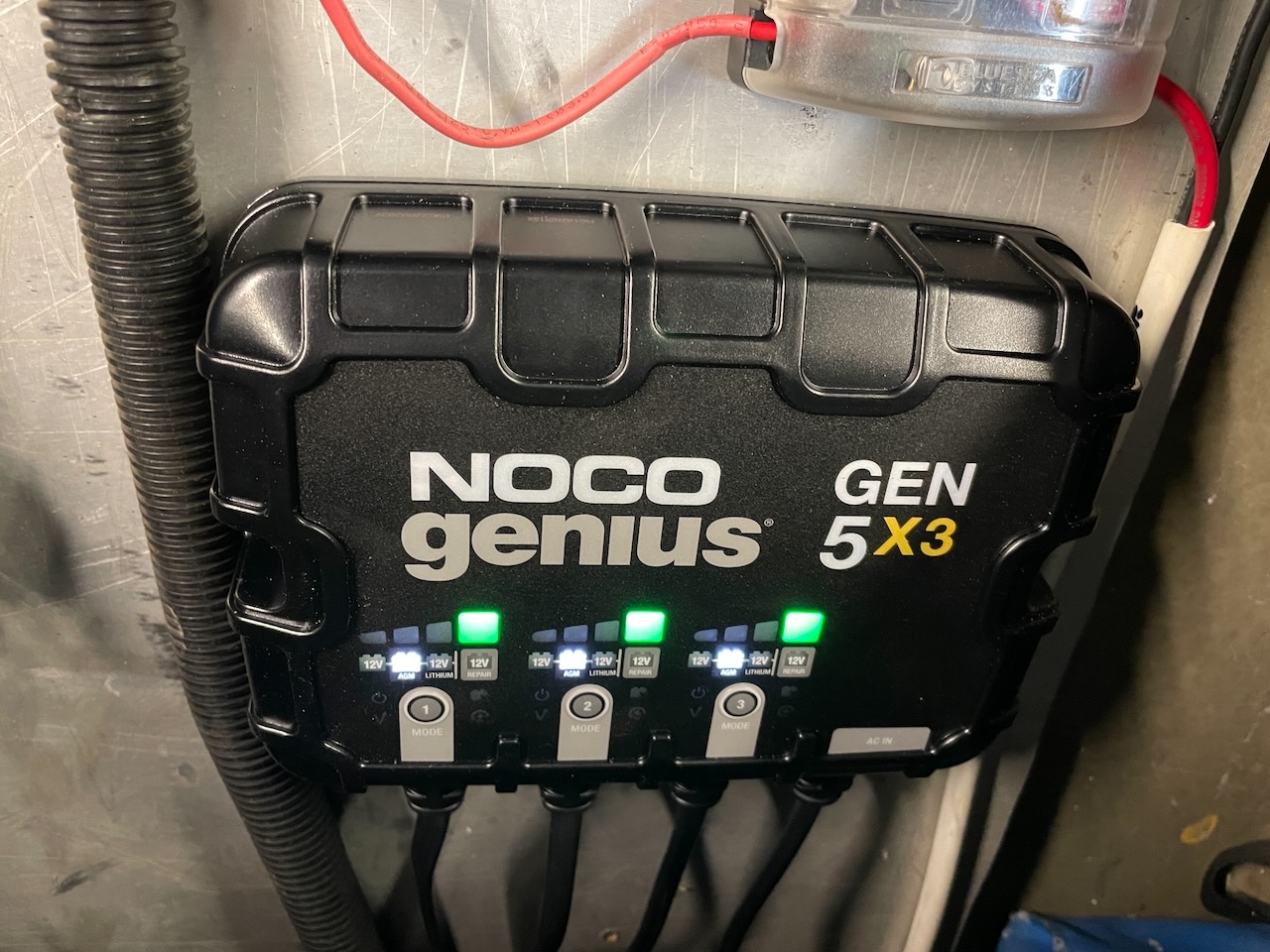 NOCO Genius 5x3 lithium-compatible three-bank charger installed in an outboard jet boat