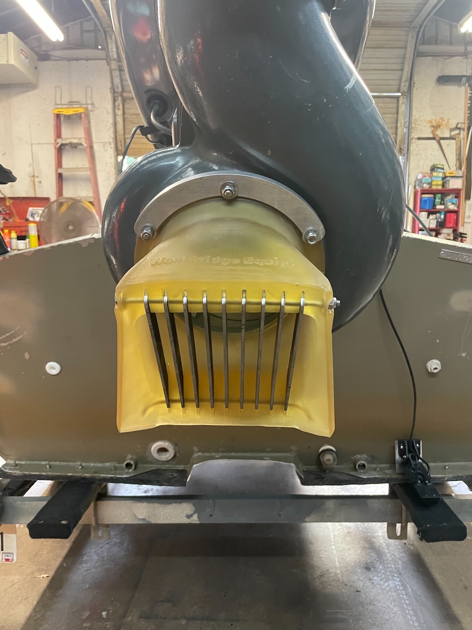 New yellow Wooldridge urethane intake installed on an outboard jet, viewed straight on from behind